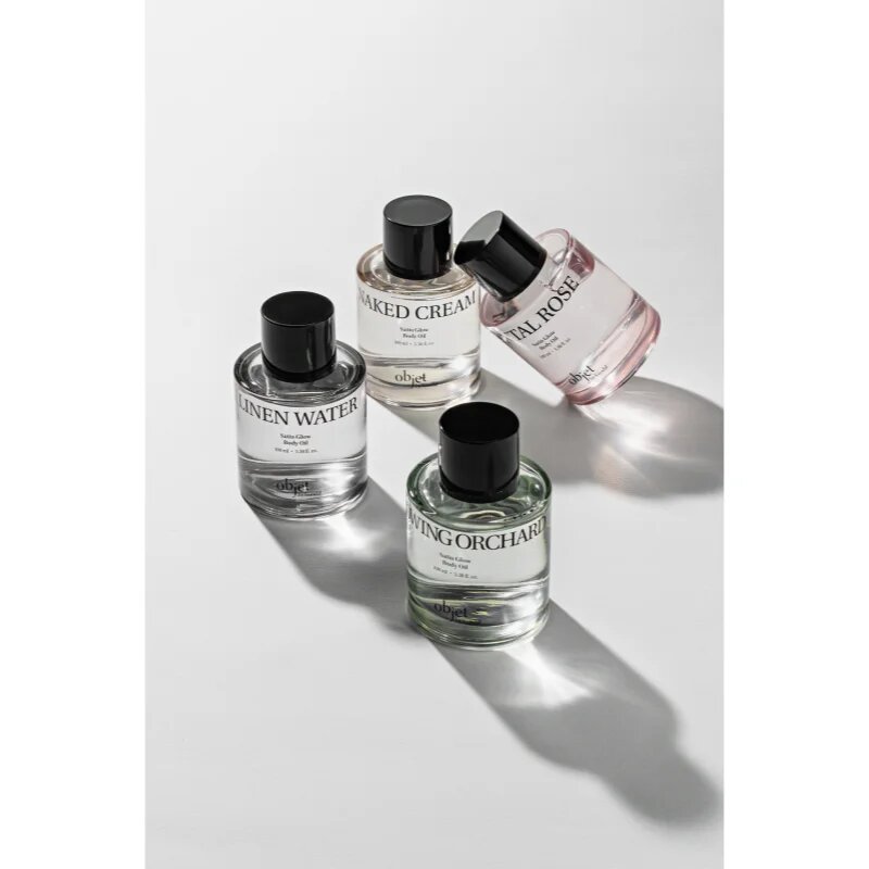 KUNDAL Objet Satin Glow Body Oil ulei de corp hranitor pentru hidratare intensa cu parfum Glowing Orchard 100 ml